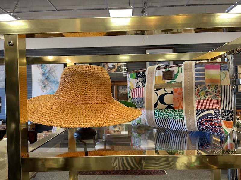 A sun hat and a handbag on display