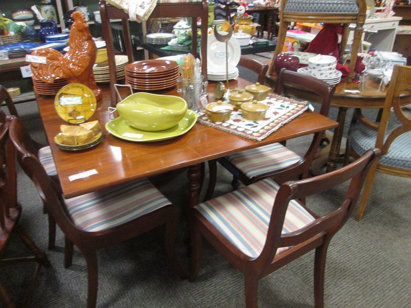 Mahogany dining table with striped upholstered chairs