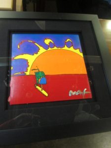 Framed Peter Max painting of a figure and sunset