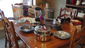 Assorted kitchen appliances and cookware on a dining table