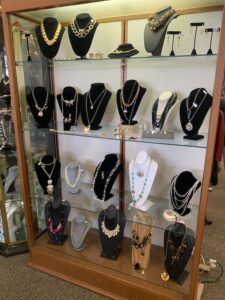 Assorted necklaces in a large display case