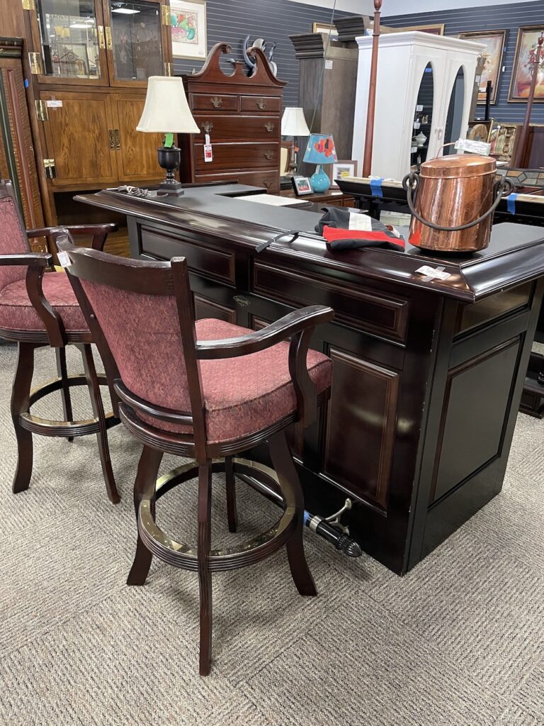 Dark wood home bar with upholstered swivel stools