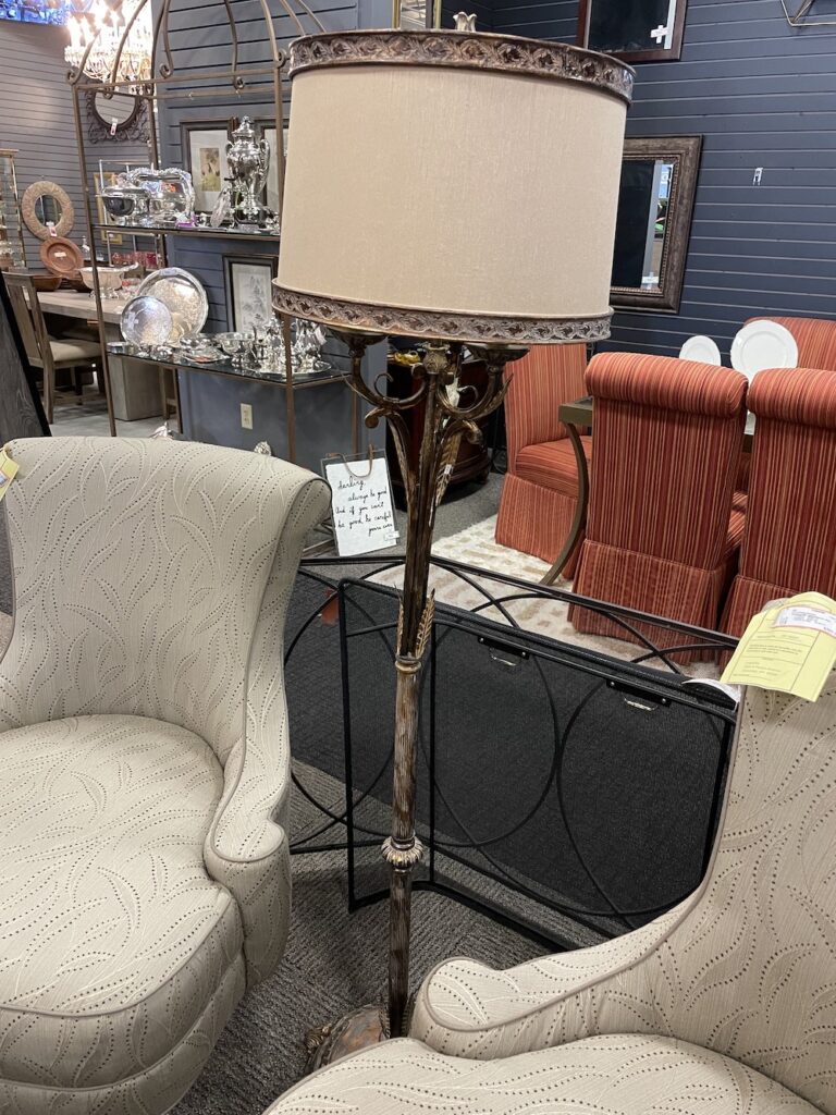 Floor lamp between two upholstered armchairs