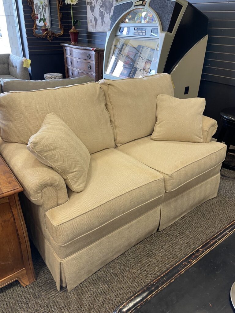 Upholstered loveseat with throw pillows