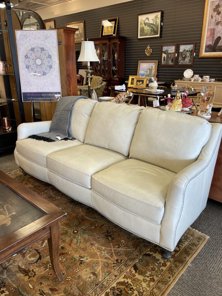 Cream leather sofa with nailhead trim