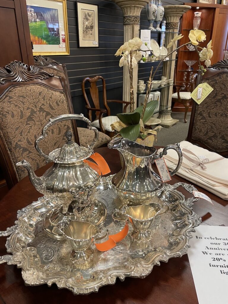 Ornate silver tea service set on a serving tray
