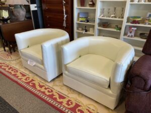 Pair of cream leather barrel chairs